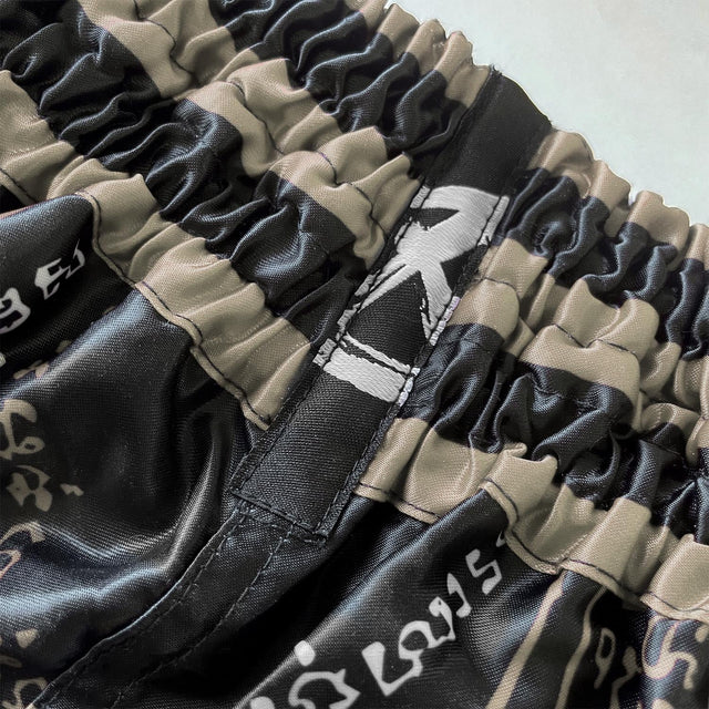 8 WEAPONS Muay Thai Shorts 8 Ways Yant 2.0 – Black/Sand