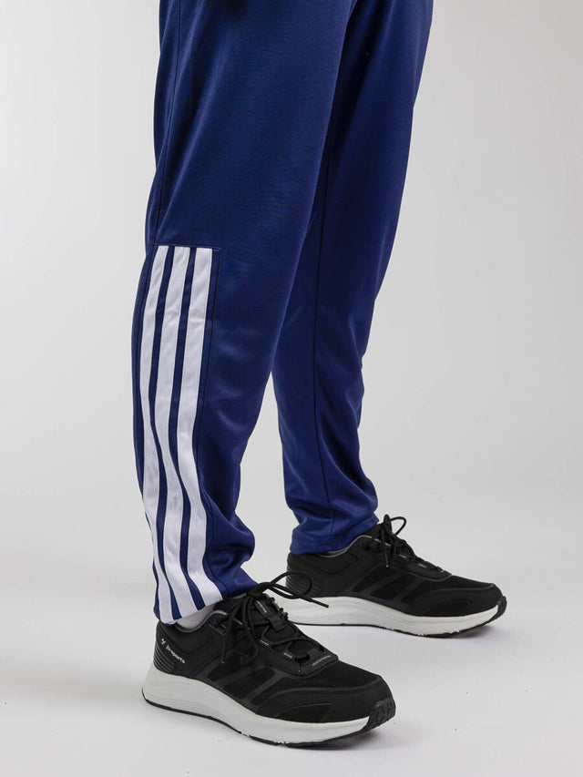 Tepláky Adidas Community Sports – Tmavě modrá/Bílá